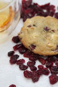 a cookie and some cranberries on a table