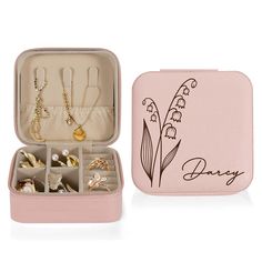 an open pink box with jewelry inside it