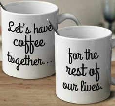 two white coffee mugs with words on them