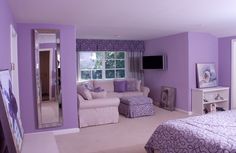 a bedroom with purple walls and white furniture