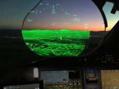 the view from inside an airplane at sunset or dawn, with green and yellow lights