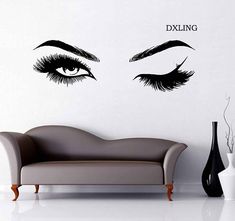 a couch sitting in front of a white wall with black eyelashes on it's face