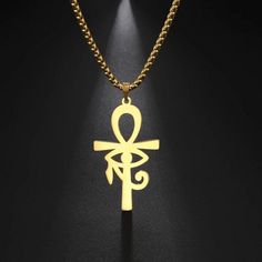 The ankh is an ancient Egyptian symbol that was most commonly used in writing to represent the word for "life" and, by extension is a symbol for life. This ankh necklace is made of solid 316L surgical stainless steel and has a high polish gold color PVD finish with the eye of Ra or Horus in the center. This amulet is reversible so that it may be worn as the eye of Ra or Horus. The Eye of Ra is a symbol of the sun. It is personified by several Egyptian goddesses, such as Wadjet, Sekhmet, Hathor, Egyptian Amulet, Eye Of Horus Necklace, Ankh Necklace, Egyptian Inspired, Eye Of Ra, Black Unicorn, Baby Black, Child Baby, Mens Jewelry Necklace