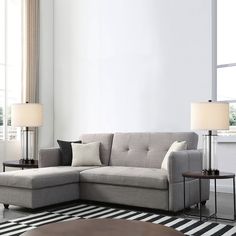 a living room with a sectional couch and two lamps