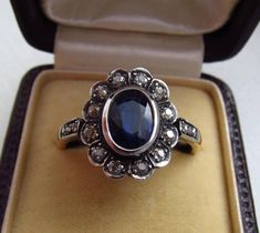 Antique diamond and kyanite cluster engagement ring, made of 14K gold and silver combination. It has a 14K gold hallmark that was used between 1867 and 1937. It was made in Austria. Total diamond weight: 0.35 carat Size of the kyanite stone: 0.291 x 0.224 inches (7.4 x 5.7 mm) Size of the head part: 0.563 x 0.469 inches (14.3 x 11.9 mm) Inside diameter: 0.6972 inches (17.71 mm) Size 7½ US Weight: 3.4 gram The box is not part of the auction. Free world-wide shipping by FedEx. Austro Hungarian, Cluster Engagement Ring, Antique Diamond, Gold And Silver, Ring Verlobung, Engagement Ring, Jewelry Rings, Wedding Rings, Engagement Rings