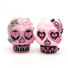 two pink and black skulls with hearts on them