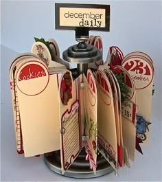 there is a display with many different cards on the stand, and one has a sign that says december daily