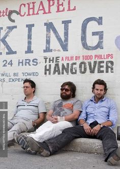 three men are sitting on a bench in front of a wall that says king 24 hrs the hangover