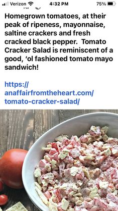 a bowl of food sitting on top of a table next to tomatoes and crackers