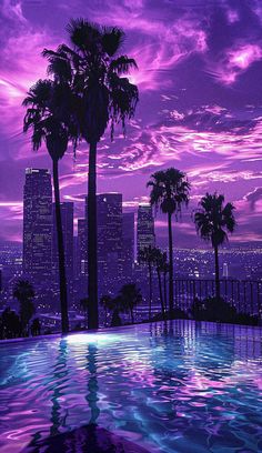 a pool with palm trees in the foreground and purple clouds in the sky above