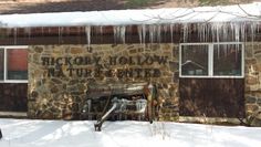 an old building with icicles hanging from it's roof and the words willow lodge written on it