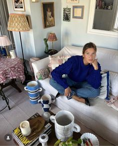 a woman sitting on top of a white couch