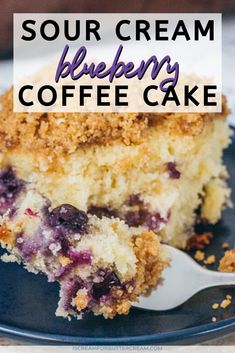 a piece of blueberry coffee cake on a black plate with a white and blue text overlay reads sour cream blueberry coffee cake