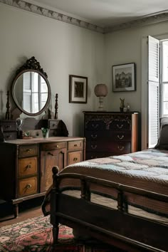 a bed sitting in a bedroom next to a dresser and mirror on top of a wooden floor