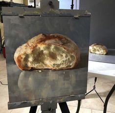 a loaf of bread sitting on top of a metal table next to a white counter