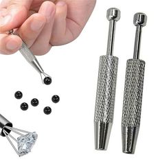 a person is holding two metal screws and some black beads on a white background