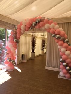 an arch made out of balloons in a room