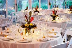 the tables are set with white linens and place settings for formal dinnereons