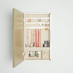 PRICES MAY VARY. Wall hanging jewelry storage mirror Storage options include 25 earring hooks, 10 necklace hooks, 7 divided compartments, a bracelet bar and ring rolls The inside is lined with a anti-tarnish linen Easy opening access design Includes mounting hardware Item Dimensions 3. 2 x 13. 5 x 24 inches Apartment Closet, Hanging Jewelry Storage, Jewlery Holder, Champagne Jewelry, Honey Store, Mirror Jewellery Cabinet, Jewelry Organizer Wall, Jewelry Wall, Hanging Jewelry Organizer