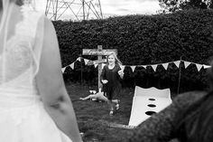 a woman in a wedding dress standing next to a man with a frisbee