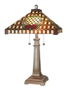 a table lamp with a stained glass shade on it's base and flowers in the center