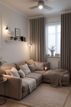 a living room filled with furniture and a large window covered in drapes, next to a rug