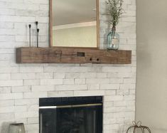 a white brick fireplace with a mirror above it