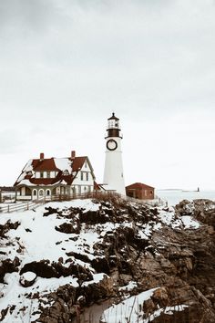 a light house sitting on top of a snow covered hill