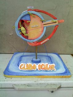 a cake that is shaped like a globe with the words club gour written on it