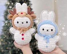 two crocheted stuffed animals are held in front of a christmas tree with snowflakes