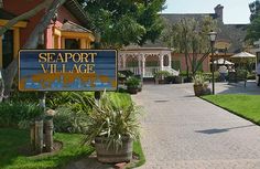 a blue and yellow sign that says seaport village