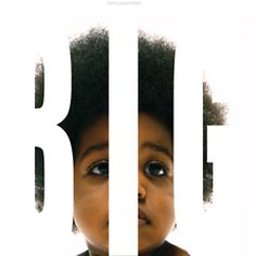 a young child with an afro stares at the camera in front of a white background