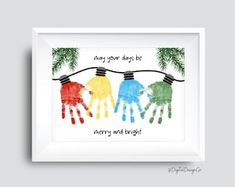 three children's handprints hanging on a clothes line with the words merry and bright