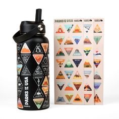 an insulated water bottle next to a card and sticker book on a white background