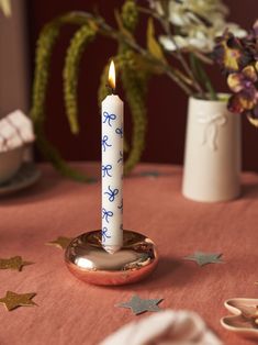 a lit candle sitting on top of a table