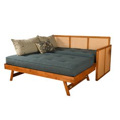 a futon bed with two pillows on it and a wooden frame around the headboard