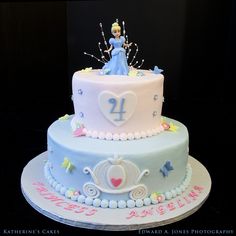 a birthday cake decorated with princess figures and decorations