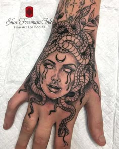 a woman's hand with a tattoo on it