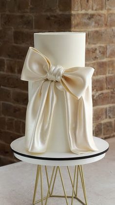 a white wedding cake with a bow on top