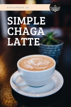 a cup of coffee sitting on top of a saucer with the words simple chaga latte