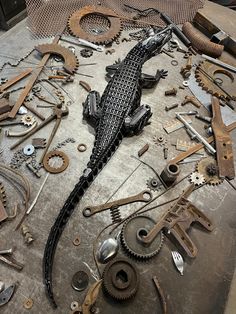 the lizard is laying on top of many different tools