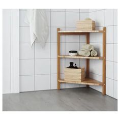 a wooden shelf with towels and soaps on it next to a white tiled wall