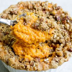 a spoonful of sweet potato casserole on top of a muffin tin