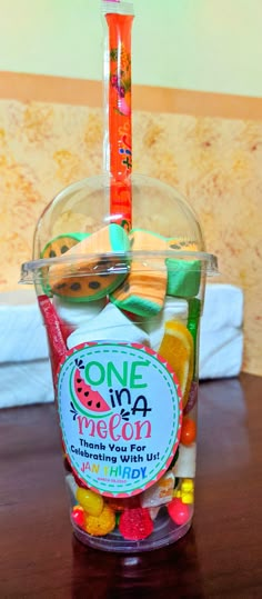 a cup filled with candy sitting on top of a wooden table