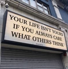 a sign on the side of a building that says, your life isn't yours if you always care what others think