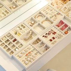 a white table topped with lots of jewelry