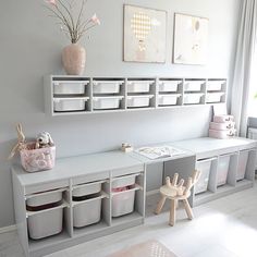 a child's playroom with toys and storage bins on the wall next to it