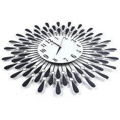 a clock made out of forks and spoons on a white surface with black numbers