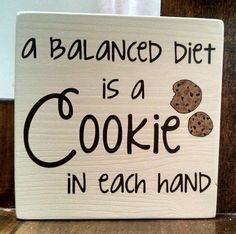 a sign that says, a balanced diet is a cookie in each hand