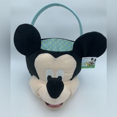 a stuffed mickey mouse head with a blue bow around it's neck and ears